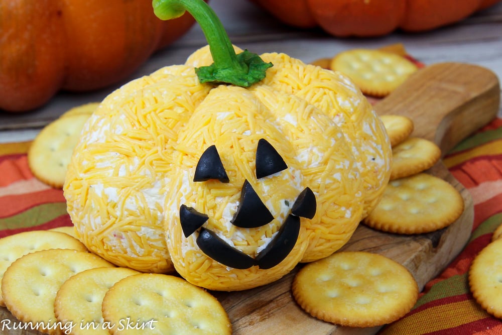 Halloween Cheese Ball on a cutting board with crackers.