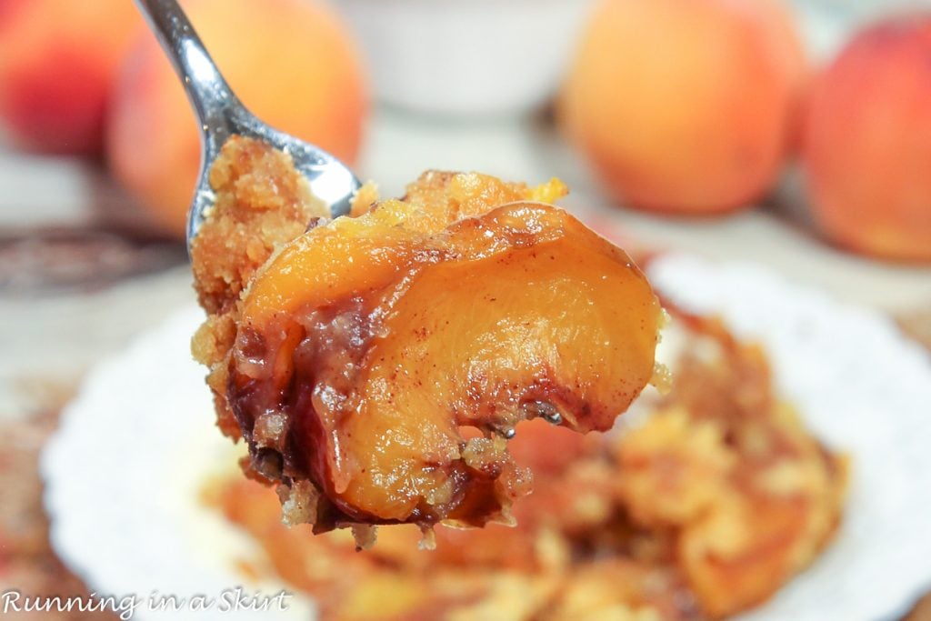 Close up of Crock Pot Peach Cobbler with Cake Mix on fork.