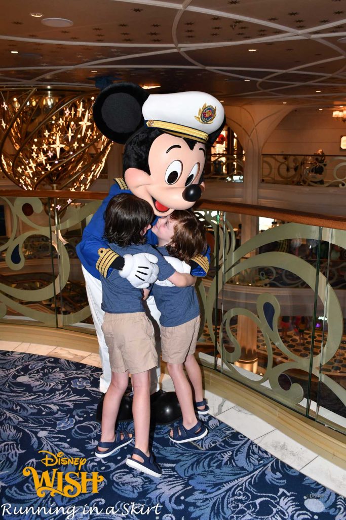 Mickey hugging kids on a Disney Cruise