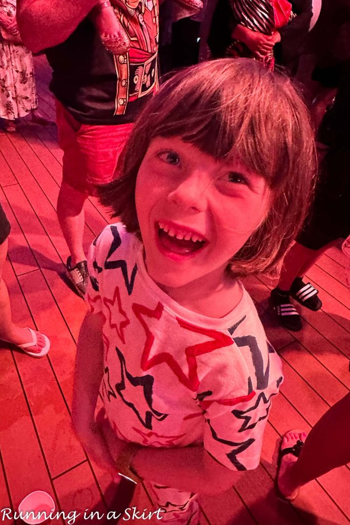 Boy watching fireworks on Disney Cruise.