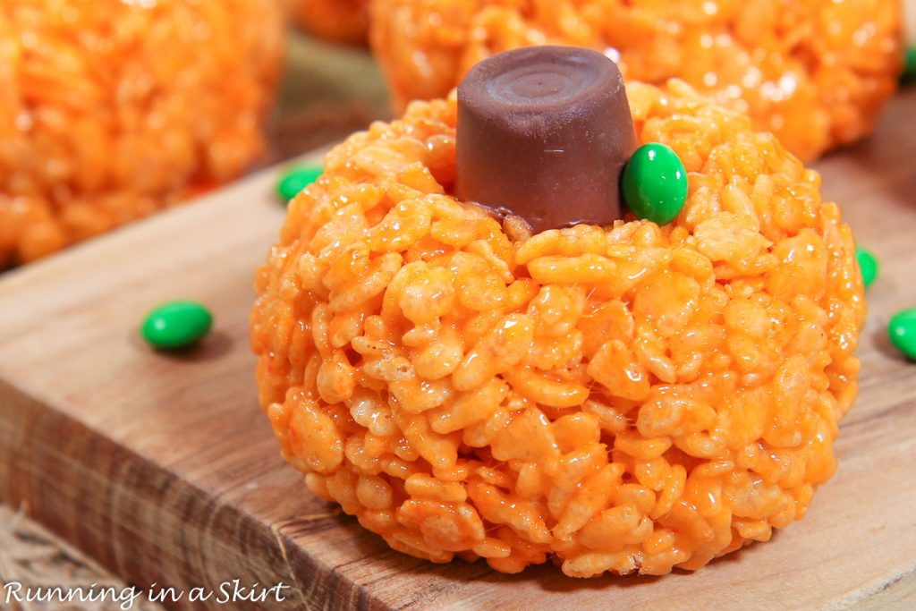 Pumpkin Rice Krispie Treat on a wood board.