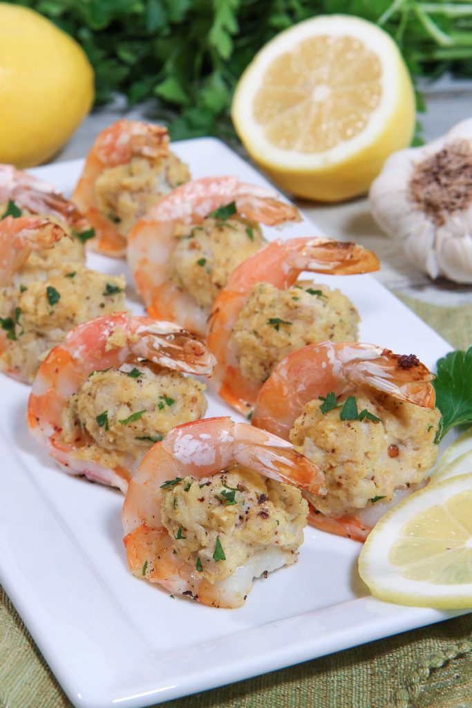 Crab Stuffed Shrimp on a serving plate with lemons.