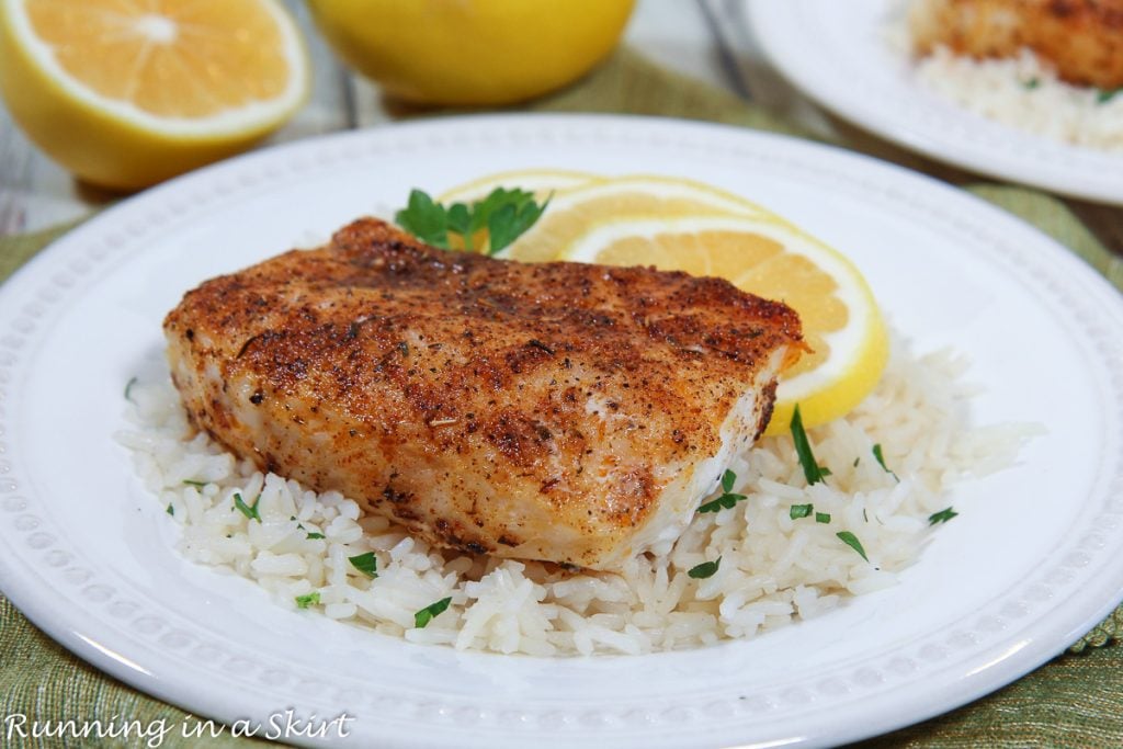 Baked Blackened Cod recipe on a white plate with rice.