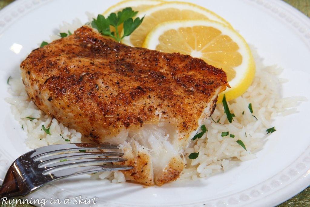 Baked Blackened Cod recipe flaking with a fork.